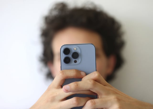 File photo of a man on his phone.
