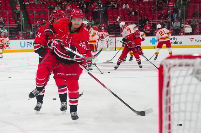 Mar 2, 2025; Raleigh, North Carolina, USA;  Carolina Hurricanes center Sebastian Aho (20) takes a shot during the warmups before the game against the Calgary Flames at Lenovo Center. Mandatory Credit: James Guillory-Imagn Images