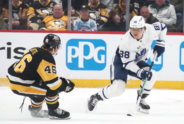 Mar 2, 2025; Pittsburgh, Pennsylvania, USA;  Toronto Maple Leafs right wing William Nylander (88) moves the puck against Pittsburgh Penguins center Blake Lizotte (46) during the third period at PPG Paints Arena. Mandatory Credit: Charles LeClaire-Imagn Images