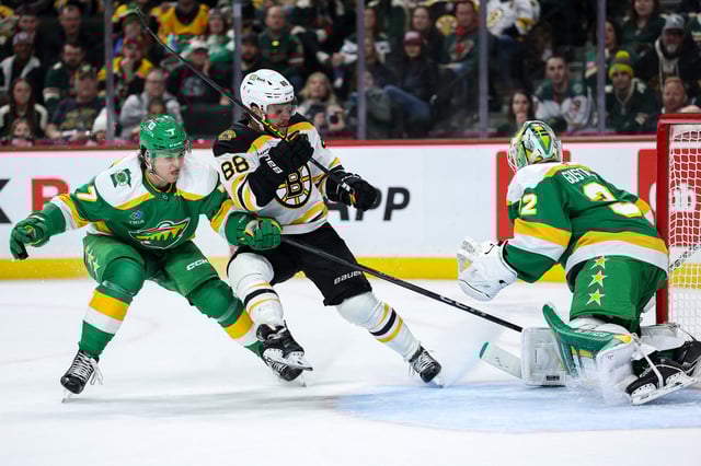 Mar 2, 2025; Saint Paul, Minnesota, USA; Minnesota Wild goaltender Filip Gustavsson (32) makes a save on a shot by Boston Bruins right wing David Pastrnak (88) during the third period at Xcel Energy Center. Mandatory Credit: Matt Krohn-Imagn Images
