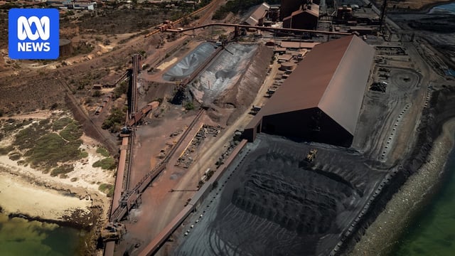 Drone shot of a steelworks factory and piles of coal