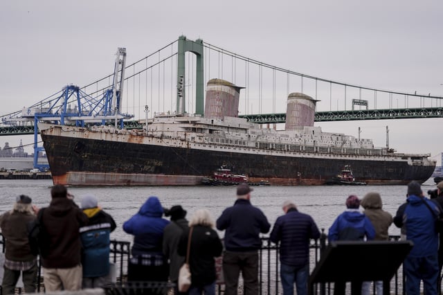 FILE - The SS United States is towed along the Delaware River between Pennsylvania and New Jersey, from Philadelphia, Feb. 19, 2025. (AP Photo/Matt Rourke, File)