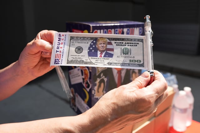 Merchandise supporting President Donald Trump appears before the start of a campaign rally, Saturday, June 22, 2024, at Temple University in Philadelphia.