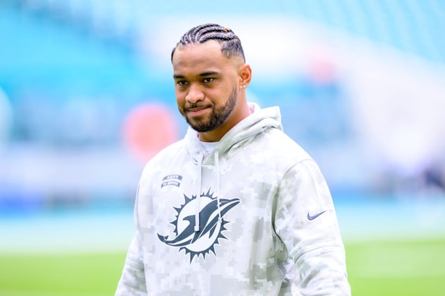 Miami Dolphins quarterback Tua Tagovailoa (1) wears a Salute to Service hoodie as he walks off of the field before an NFL football game against the Las Vegas Raiders, Sunday, Nov. 17, 2024, in Miami Gardens, Fla. (AP Photo/Doug Murray)