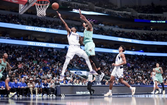 Feb 27, 2025; Dallas, Texas, USA;  Dallas Mavericks guard Kyrie Irving (11) shoots past Charlotte Hornets forward Miles Bridges (0) during the second half at American Airlines Center. Mandatory Credit: Kevin Jairaj-Imagn Images/File Photo