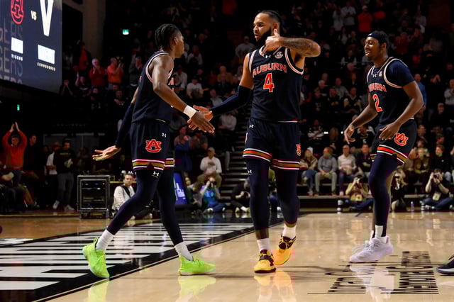 Feb 11, 2025; Nashville, Tennessee, USA;  Auburn Tigers forward Johni Broome (4) reacts after a made three-point basket by guard Denver Jones (2) against the Vanderbilt Commodores during the first half at Memorial Gymnasium. Mandatory Credit: Steve Roberts-Imagn Images/File Photo