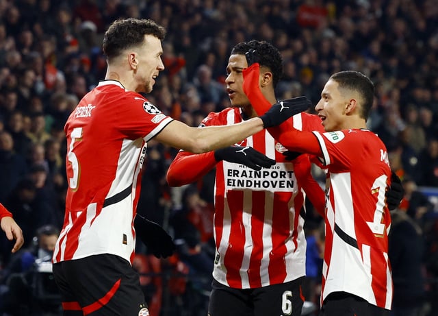 Soccer Football - Champions League - Knockout Phase Playoff - Second Leg - PSV Eindhoven v Juventus - Philips Stadion, Eindhoven, Netherlands - February 19, 2025 PSV Eindhoven's Ivan Perisic celebrates scoring their first goal with Ryan Flamingo and Mauro Junior REUTERS/Piroschka Van De Wouw/File Photo