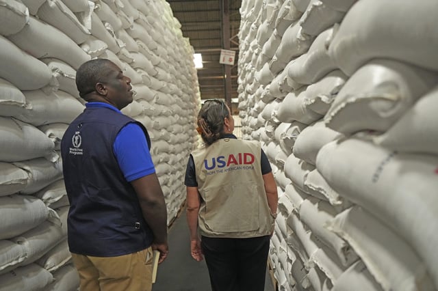 FILE - Officials from USAID and WFP inspect a donation of $11 million worth of food aid at a ceremony in Harare, Zimbabwe, Jan 17. 2024. (AP Photo/Tsvangirayi Mukwazhi, File)