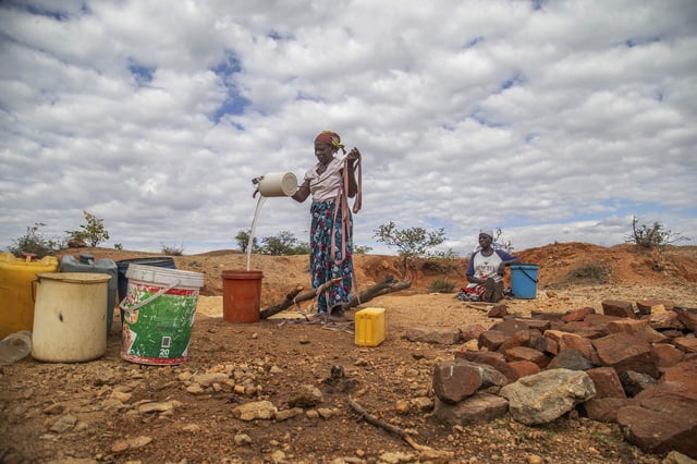 FILE - Villagers fetch water from a makeshift borehole in Mudzi, Zimbabwe, July 2, 2024. (AP Photo/Aaron Ufumeli, File)
