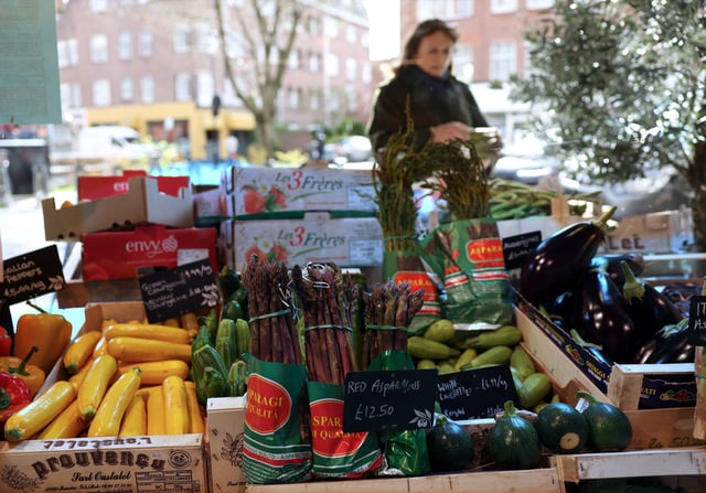 A customer shops for vegetables at gourmet grocery store Andreas, in London, Britain, March 28, 2024. REUTERS/Isabel Infantes/File Photo
