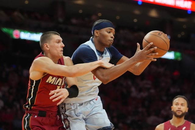 Washington Wizards guard Bilal Coulibaly (0) and Miami Heat guard Tyler Herro (14) go after the rebound during the first half of an NBA basketball game, Monday, March 3, 2025, in Miami. (AP Photo/Marta Lavandier)