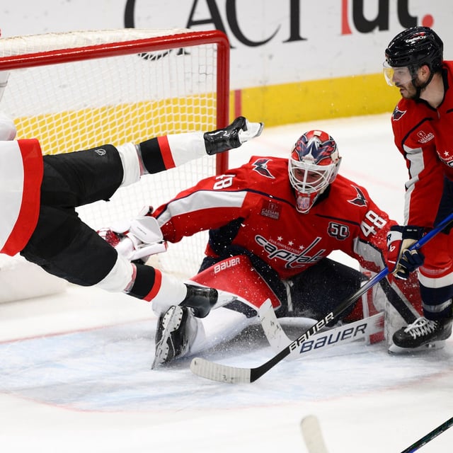 Ottawa Senators center Tim Stützle (18) trips over Washington Capitals goaltender Logan Thompson (48) during the third of an NHL hockey game, Monday, March 3, 2025, in Washington. (AP Photo/Nick Wass)