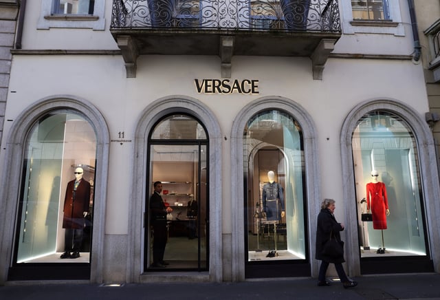 A person walks outside a Versace store in Corso Montenapoleone in Milan, Italy, January 10, 2025. REUTERS/Claudia Greco/File Photo