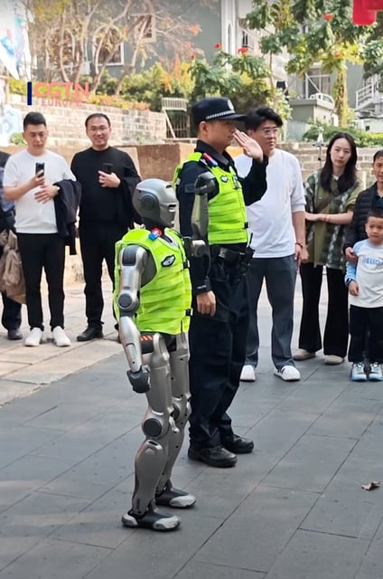 A viral video showcases the PM01 robot, above, walking in formation with police officers and enthusiastically shaking hands with passers-by. YouTube/CGTN