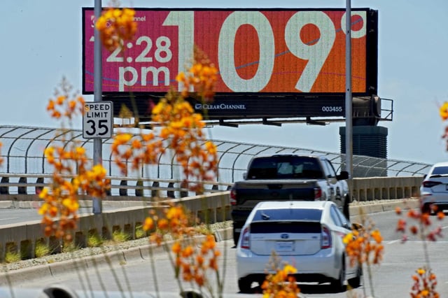 A downtown digital billboard displays an unofficial temperature on July 17, 2023, in Phoenix, the nation’s hottest large city. As climate change makes extreme heat events more common, a new study says older adults who live in very hot regions may age faster biologically than those in cooler climates.