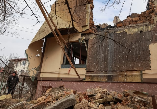 A resident stands near his building hit by a Russian drone strike, amid Russia's attack on Ukraine, in Odesa, Ukraine March 4, 2025. REUTERS/Nina Liashonok