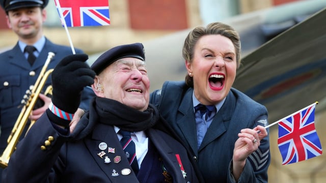 Henry Rice, 98, a veteran of the Normandy invasion, with Katie Ashby of the D-Day Darlings, a group who sing hits from the time. They were outside the Royal Albert Hall with a replica Spitfire to mark the 80-day countdown to the 80th anniversary VE Day commemorations