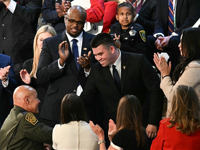 Jason Hartley (C) stands after US President Donald Trump announced that Hartley has been admitted to the US Military Academy West Point during Trump's address to a joint session of Congress in the House Chamber of the US Capitol in Washington, DC, on March 4, 2025. (Photo by Jim WATSON / AFP) (Photo by JIM WATSON/AFP via Getty Images)
