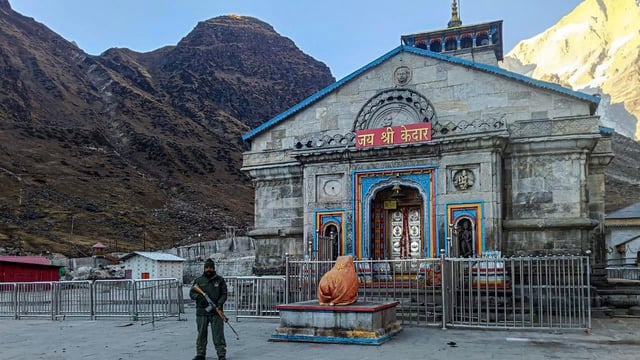 Security personnel stand guard outside the Kedarnath Temple as it remains closed during the Winter season, in Rudraprayag on Saturday.