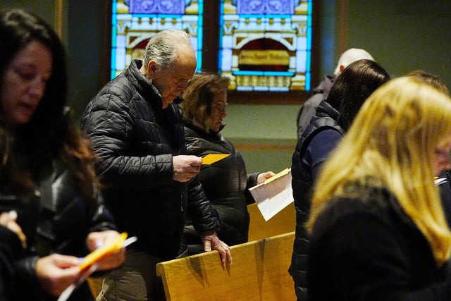 Parishioners read and recite a special prayer for Pope Francis at Holy Trinity Church in Webster, New York, on March 5, 2025.