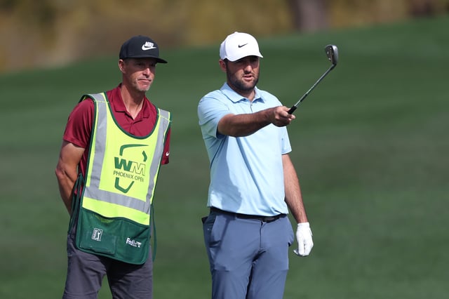 Scottie Scheffler of the United States prepares to plays a shot on the second hole alongside his caddie during the second round of the WM Phoenix Open 2025 at TPC Scottsdale on February 07, 2025 in Scottsdale, Arizona.