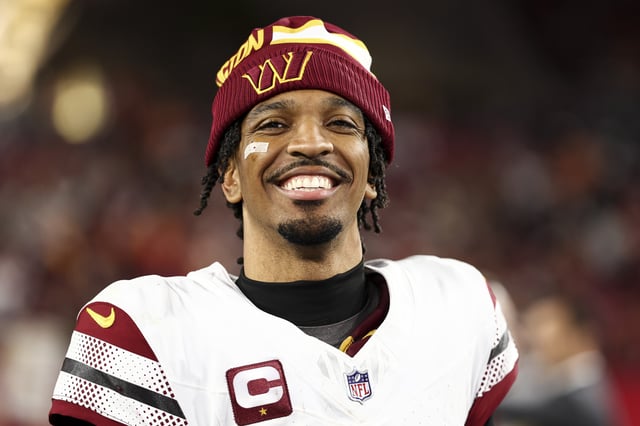 Jayden Daniels #5 of the Washington Commanders smiles after an NFL football wild card playoff game against the Tampa Bay Buccaneers at Raymond James Stadium on January 12, 2025 in Tampa, Florida.