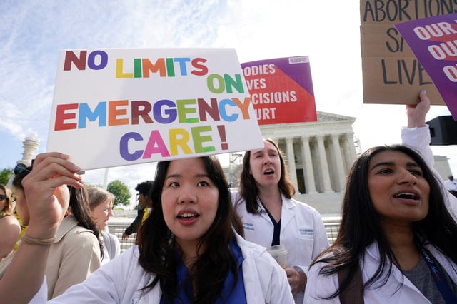 Abortion rights supporters hold placards on the day the Supreme Court justices hear oral arguments over the legality of Idaho's Republican-backed, near-total abortion ban in medical-emergency situations, at the U.S. Supreme Court in Washington, U.S., April 24, 2024.