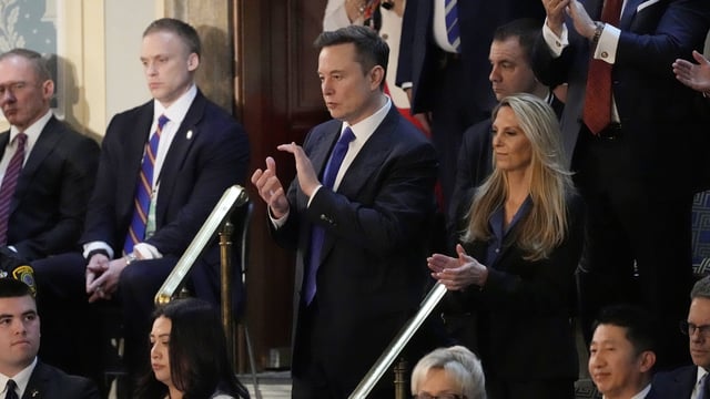 Elon Musk, center, applauds as President Donald Trump addresses a joint session of Congress at the Capitol in Washington, Tuesday, March 4, 2025. (AP Photo/Ben Curtis)