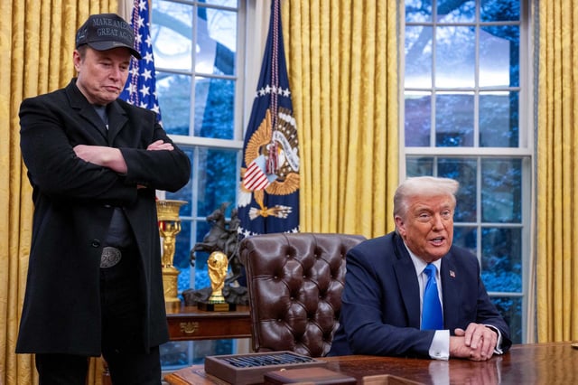 Elon Musk, left, listens as President Donald Trump speaks in the Oval Office on Feb. 11, 2025.