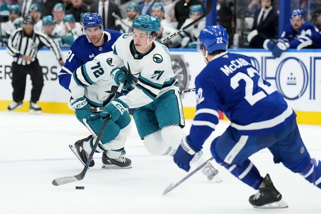 San Jose Sharks forward Macklin Celebrini (71) breaks past Toronto Maple Leafs defenceman Jake McCabe (22) during first period NHL hockey action in Toronto, Monday, March 3, 2025. THE CANADIAN PRESS/Nathan Denette