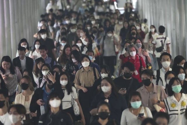 FILE - Peoples wear face masks to protect themselves from air pollution in Bangkok, Thailand, Feb. 6, 2025, (AP Photo/Sakchai Lalit, File)