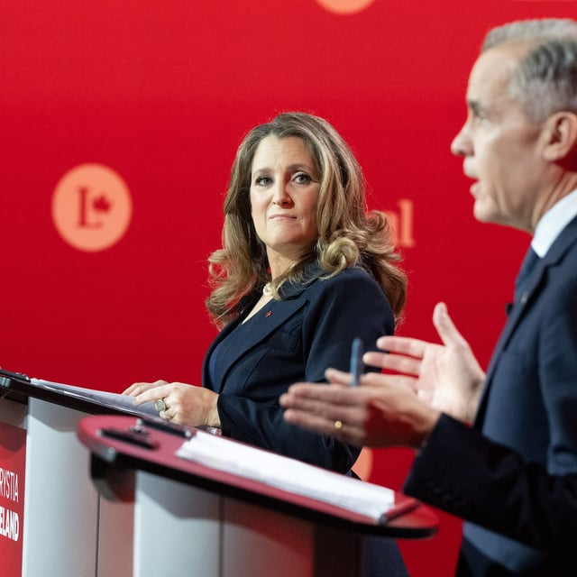 Liberal Party of Canada leadership candidate Chrystia Freeland looks over as Mark Carney speaks during the English-language Liberal Leadership debate in Montreal on Tuesday, Feb.25, 2025. The Federal Liberals will pick a new leader on March 9. THE CANADIAN PRESS/Christinne Muschi