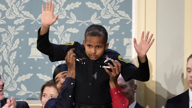 Devarjay DJ Daniel waves as President Donald Trump addresses a joint session of Congress in the House chamber at the U.S. Capitol in Washington, Tuesday, March 4, 2025. 