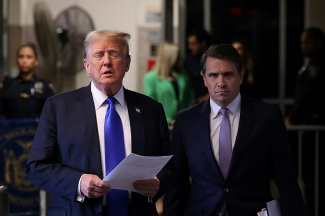 Todd Blanche (R) listens as Donald Trump speaks to reporters at his hush money trial in Manhattan