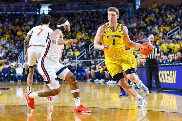 Danny Wolf #1 of the Michigan Wolverines drives to the basket against Kylan Boswell #4 of the Illinois Fighting Illini during the first half of a college basketball game at Crisler Arena on March 02, 2025 in Ann Arbor, Michigan. The Illinois Fighting Illini won the game 93-73.