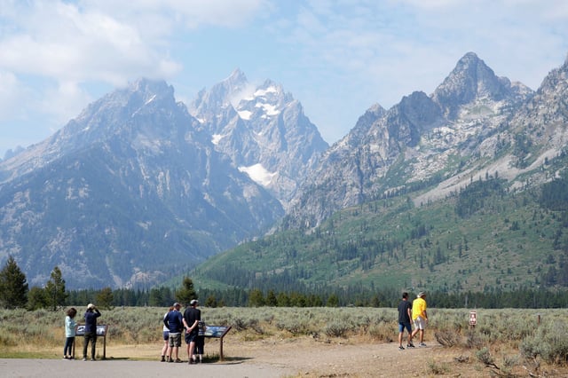 People read signs near String Lake on Aug. 8, 2024, in Grand Teton National Park, Wyo. 
