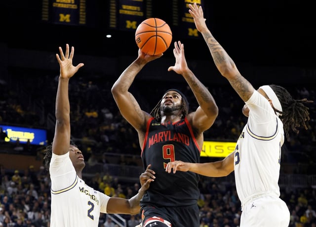 Maryland guard Selton Miguel (9) goes to the basket between Michigan guard L.J. Cason (2) and guard Rubin Jones, right, during the first half of an NCAA college basketball game Wednesday, March 5, 2025, in Ann Arbor, Mich. (AP Photo/Duane Burleson)