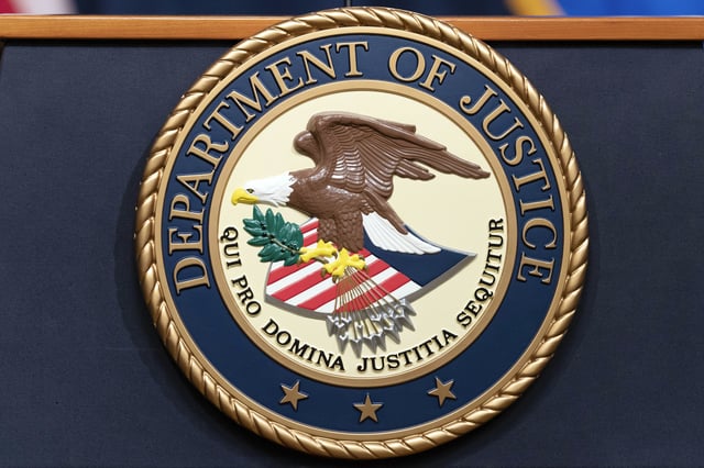 FILE - The Department of Justice seal is seen during a news conference at the DOJ office in Washington, May 16, 2023. 