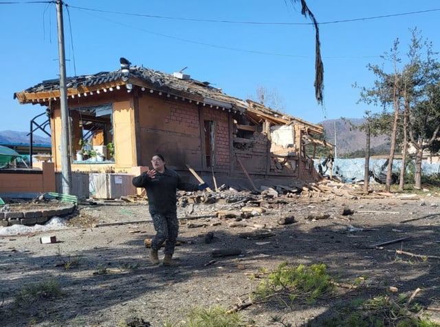 A South Korean soldier gestures near a bomb accident site outside a military live-fire training range in Pocheon on March 6, 2025. South Korea's Air Force said on March 6, that one of its fighter jets had accidentally dropped eight bombs in the wrong place during a training exercise, resulting in civilians being injured. (Photo by YONHAP / AFP) / - South Korea OUT / NO ARCHIVES -  RESTRICTED TO SUBSCRIPTION USE (Photo by -/YONHAP/AFP via Getty Images)          