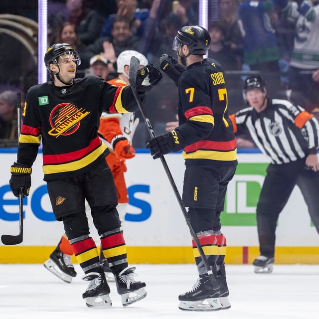 Vancouver Canucks' Teddy Blueger (53) and Kiefer Sherwood (44) come to celebrate with Carson Soucy (7) after his goal against the Anaheim Ducks during the second period of an NHL hockey game in Vancouver, B.C., on Wednesday, March 5, 2025. THE CANADIAN PRESS/Ethan Cairns