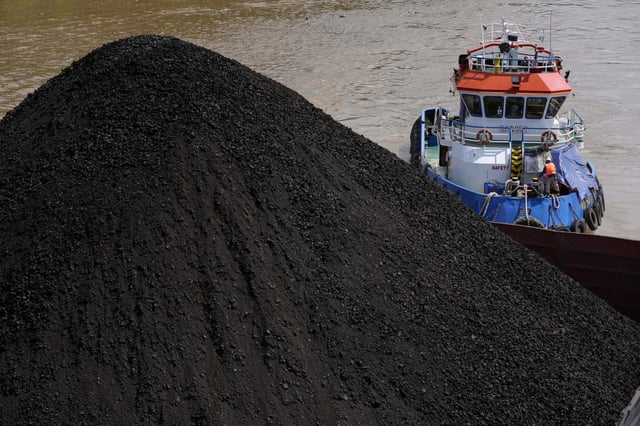 FILE - A tugboat pushes a barge carrying coal on Mahakam river in Samarinda, East Kalimantan, Indonesia, Dec. 19, 2022. (AP Photo/Dita Alangkara, File)