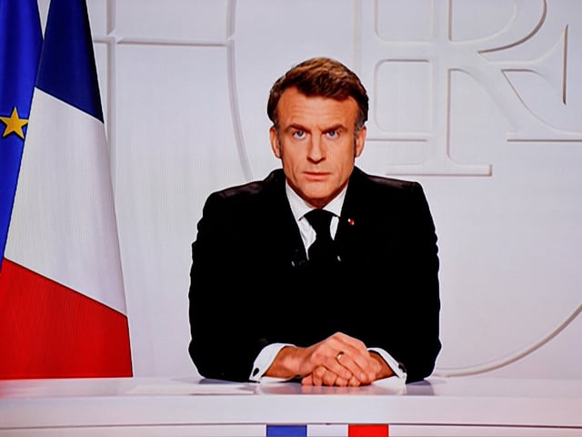 This photograph taken on March 5, 2025, shows a television screen broadcasting France's President Emmanuel Macron addressing a live interview on French TV at the Elysee Presidential Palace in Paris. Emmanuel Macron announced on March 5, 2025, that France will gather next week in Paris the chiefs of staff from countries ready to guarantee a future peace in Ukraine. (Photo by Ludovic MARIN / AFP) (Photo by LUDOVIC MARIN/AFP via Getty Images)