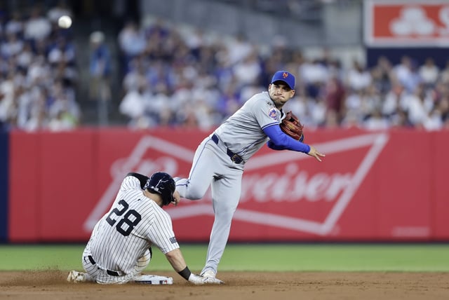 NEW YORK, NEW YORK - JULY 24: Jose Iglesias #11 of the New York Mets attempts a fourth inning double play after forcing out Austin Wells #28 of the New York Yankees at Yankee Stadium on July 24, 2024 in New York City.