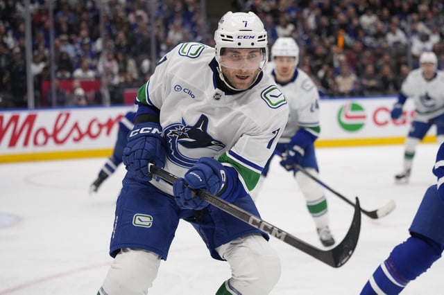 Jan 11, 2025; Toronto, Ontario, CAN; Vancouver Canucks defenseman Carson Soucy (7) goes after a loose puck against the Toronto Maple Leafs during the third period at Scotiabank Arena. Mandatory Credit: John E. Sokolowski-Imagn Images/File Photo