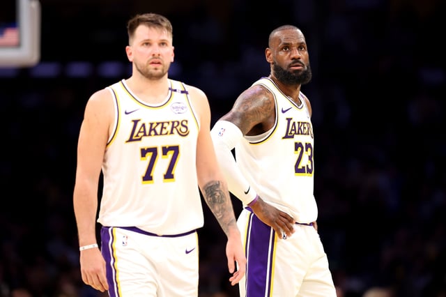 LOS ANGELES, CALIFORNIA - MARCH 02: (L-R) Luka Doncic #77 and LeBron James #23 of the Los Angeles Lakers look on against the LA Clippers at Crypto.com Arena on March 02, 2025 in Los Angeles, California.