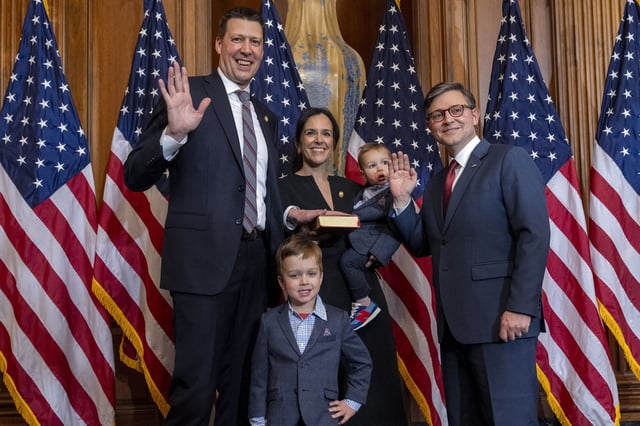 FILE - House Speaker Mike Johnson, R-La., right, poses during a ceremonial swearing-in with Rep. Josh Riley, D-N.Y., left, and members of his family, in the Rayburn Room at the Capitol in Washington, Jan. 3, 2025. (AP Photo/Jacquelyn Martin, File)