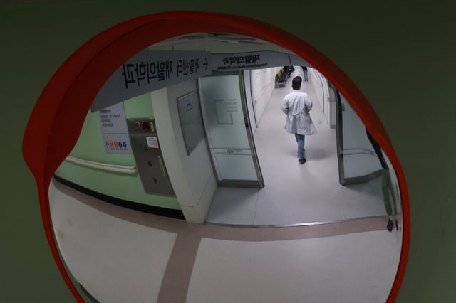 A medical worker walks at Pusan National University Hospital in Busan, South Korea, February 21, 2024.