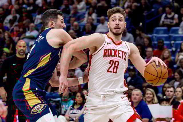Mar 6, 2025; New Orleans, Louisiana, USA;  Houston Rockets center Alperen Sengun (28) dribbles against New Orleans Pelicans center Karlo Matkovic (17) during the second half at Smoothie King Center. Mandatory Credit: Stephen Lew-Imagn Images
