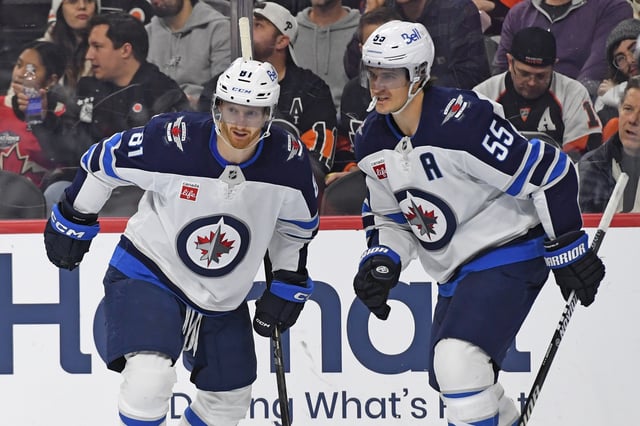 Mar 6, 2025; Philadelphia, Pennsylvania, USA; Winnipeg Jets left wing Kyle Connor (81) celebrates his goal with center Mark Scheifele (55) against the Philadelphia Flyers during the second period at Wells Fargo Center. Mandatory Credit: Eric Hartline-Imagn Images