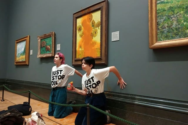Just Stop Oil climate campaigners glued their hands to the wall under Vincent van Gogh's "Sunflowers" after throwing tomato soup on the painting at the National Gallery in central London in October 2022